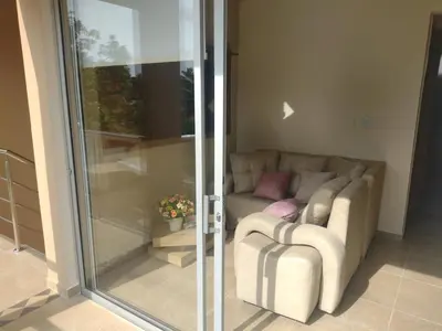 a living room with a couch and a sliding glass door at Cabañas OnBeach in San Antero