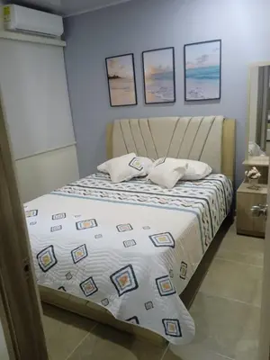a bedroom with a bed with a comforter and pillows at Cabañas OnBeach in San Antero