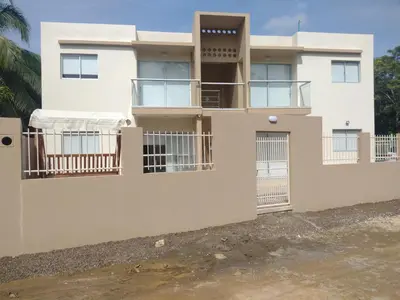 a white house with a fence in front of it at Cabañas OnBeach in San Antero