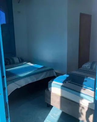 two bunk beds in a room with blue lighting at Casa Santorini in Cartagena de Indias