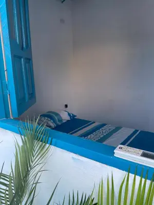 a bedroom with a bed and a swimming pool at Casa Santorini in Cartagena de Indias