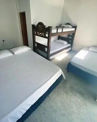 a bedroom with two beds and a shelf in it at Casa Santorini in Cartagena de Indias