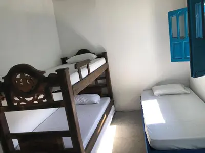 a bedroom with two bunk beds in a room at Casa Santorini in Cartagena de Indias