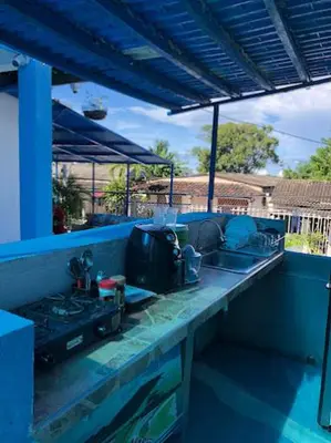 a kitchen counter with a sink and a stove at Casa Santorini in Cartagena de Indias