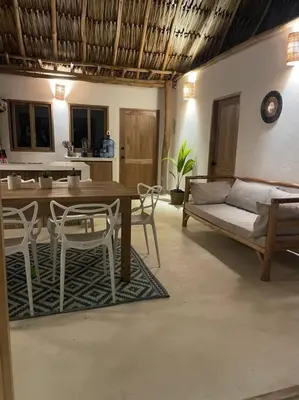 a living room with a table and chairs and a couch at Casita del Viento in San Bernardo del Viento