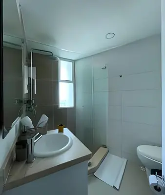 a white bathroom with a sink and a mirror at 2 Dormitorios Morros. Vista Ciénaga y salida playa in Cartagena de Indias