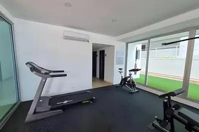 a gym with a treadmill and two exercise bikes at 2 Dormitorios Morros. Vista Ciénaga y salida playa in Cartagena de Indias