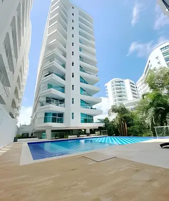 a swimming pool in front of a tall building at 2 Dormitorios Morros. Vista Ciénaga y salida playa in Cartagena de Indias