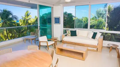 a living room with a couch and tables and windows at Magico Apartamento Frente al Mar 4 Habitaciones PAZ335 in Coveñas