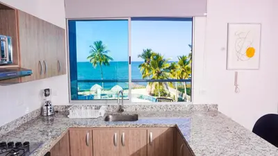 a kitchen with a view of the ocean from a window at Magico Apartamento Frente al Mar 4 Habitaciones PAZ335 in Coveñas