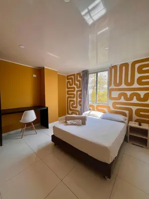 a bedroom with a large bed and a window at Hotel Paranawa in Baranoa