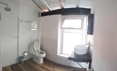 a bathroom with a sink and a toilet and a window at EMMA HOTEL SAN DIEGO in Cartagena de Indias