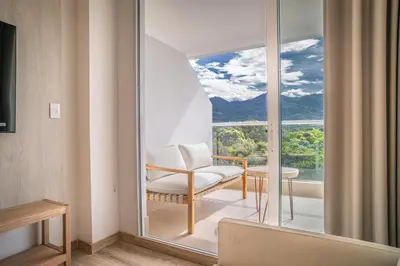 a room with a chair and a large window at Wyndham Residences Santa Marta Aluna Beach Club in Santa Marta