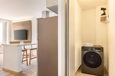 a kitchen with a washing machine in a room at Wyndham Residences Santa Marta Aluna Beach Club in Santa Marta