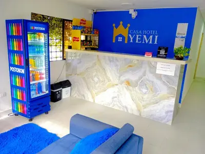 a room with a blue couch in a store at CASA HOTEL YEMI in Barranquilla