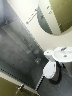 a bathroom with a toilet and a sink and a mirror at CASA HOTEL YEMI in Barranquilla