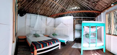 a bedroom with a bed and a ladder in a room at Cabañas La Múcura in San Onofre