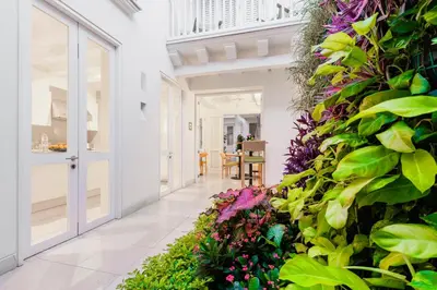 a hallway with a wall of plants and flowers at Casa La Cartujita in Cartagena de Indias