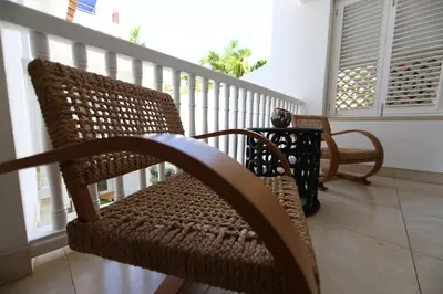 a porch with a chair and a table on a balcony at Casa La Cartujita in Cartagena de Indias