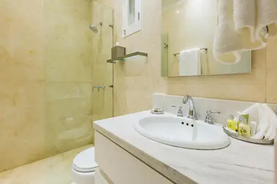 a bathroom with a sink and a shower and a toilet at Casa La Cartujita in Cartagena de Indias