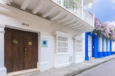 a building with a wooden door on a street at Casa La Cartujita in Cartagena de Indias