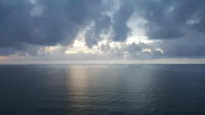 a stormy sky over the ocean with the sun reflecting on the water at Apto en Cartagena de Indias in Cartagena de Indias