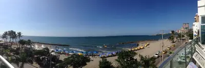 a beach with umbrellas and people in the water at Apto en Cartagena de Indias in Cartagena de Indias