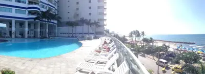 a view of a hotel with a swimming pool and the ocean at Apto en Cartagena de Indias in Cartagena de Indias