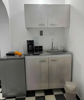 a kitchen with white cabinets and a sink and a toilet at Céntrico y confortable apto Casa Doña Yola 3 in Cartagena de Indias