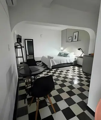 a bedroom with a bed and a checkered floor at Céntrico y confortable apto Casa Doña Yola 3 in Cartagena de Indias