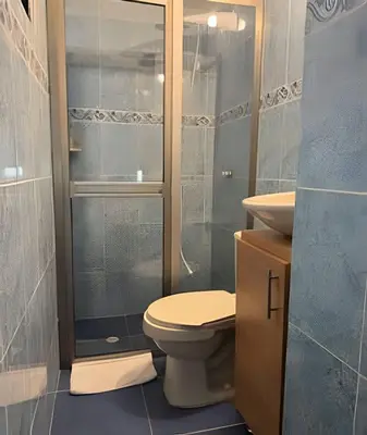 a bathroom with a toilet and a glass shower at Céntrico y confortable apto Casa Doña Yola 4 in Cartagena de Indias