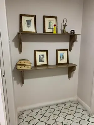 a room with three shelves on the wall with pictures at Apartahotel Edificio Baquero x5 Apto 301 in Barranquilla