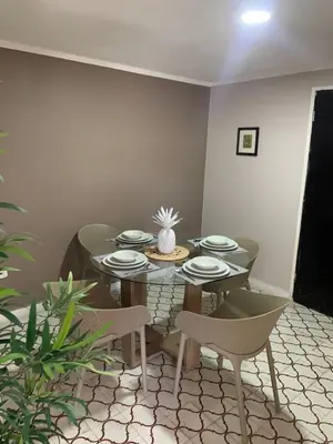 a dining room with a table with plates and chairs at Apartahotel Edificio Baquero x5 Apto 301 in Barranquilla
