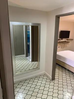 a mirror in a room with a bedroom and a bed at Apartahotel Edificio Baquero x5 Apto 201 in Barranquilla
