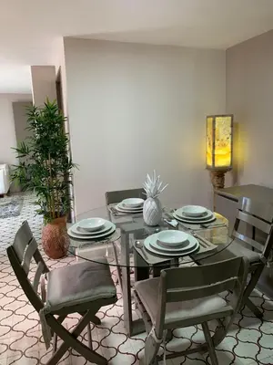 a dining room with a glass table and chairs at Apartahotel Edificio Baquero x5 Apto 201 in Barranquilla