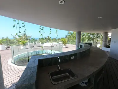 a kitchen with a sink and a view of a patio at exclusivo apartamento con doble vista al mar en santa marta # in Santa Marta