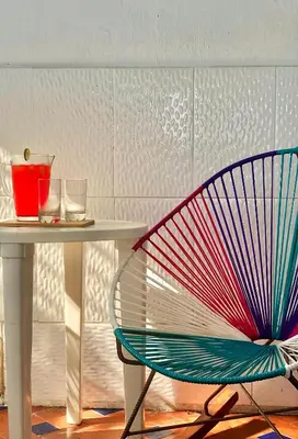 a colorful chair sitting next to a table at Acogedor apartamento en bruselas in Cartagena de Indias