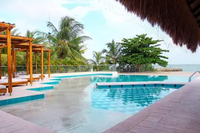 a swimming pool with a view of the ocean at Exclusiva casa en Baru con piscina y playa privada in Playa Blanca