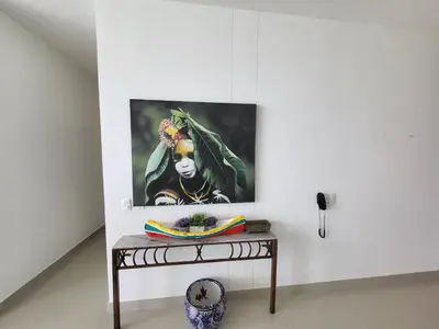 a painting of a woman on a table in a room at Yellow beach & rest in Coveñas
