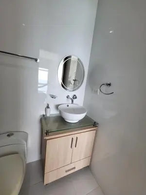 a white bathroom with a sink and a mirror at Yellow beach & rest in Coveñas