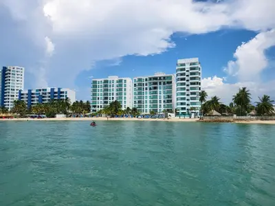 a view of a city from the water with buildings at Yellow beach & rest in Coveñas