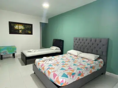 a bedroom with a bed and a bed and a bedskirtspectspectspectspects at HOTEL SANTA MONICA in Barranquilla