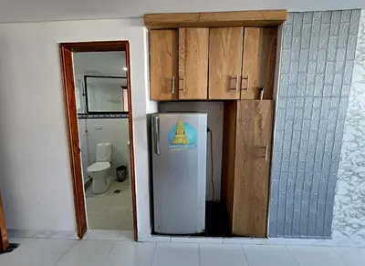 a kitchen with a refrigerator in a room with a toilet at Estudio Vista Laguna y Mar Piso 14 in Cartagena de Indias