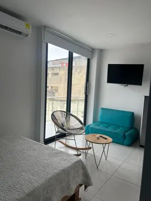 a bedroom with a blue couch and a chair at Edificio Buenos Aires apartamento 304 moderno Sincelejo in Sincelejo