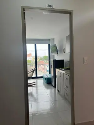 a kitchen with a door open to a kitchen with a view at Edificio Buenos Aires apartamento 304 moderno Sincelejo in Sincelejo