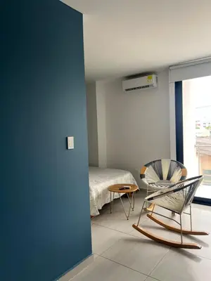 a room with a bed and a chair and a table at Edificio Buenos Aires apartamento 304 moderno Sincelejo in Sincelejo