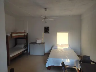 a bedroom with a bed and a ceiling fan at La Casa del Mar - Hotel Familiar en San Bernardo del Viento in San Bernardo del Viento