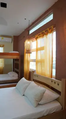 a bedroom with two bunk beds and a window at Los Cayos Cabañas in Coveñas