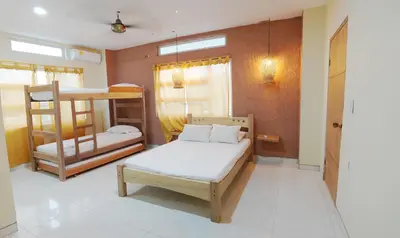 a room with a bed and bunk beds in it at Los Cayos Cabañas in Coveñas