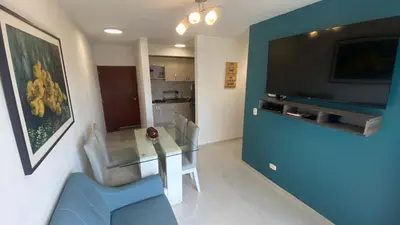 a living room with a dining table and a television at Nice apartment close to the Marbella beach in Cartagena de Indias